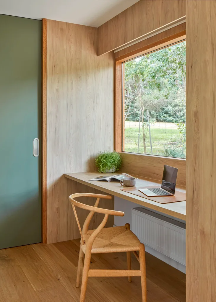 A built-in study space overlooking a verdant view