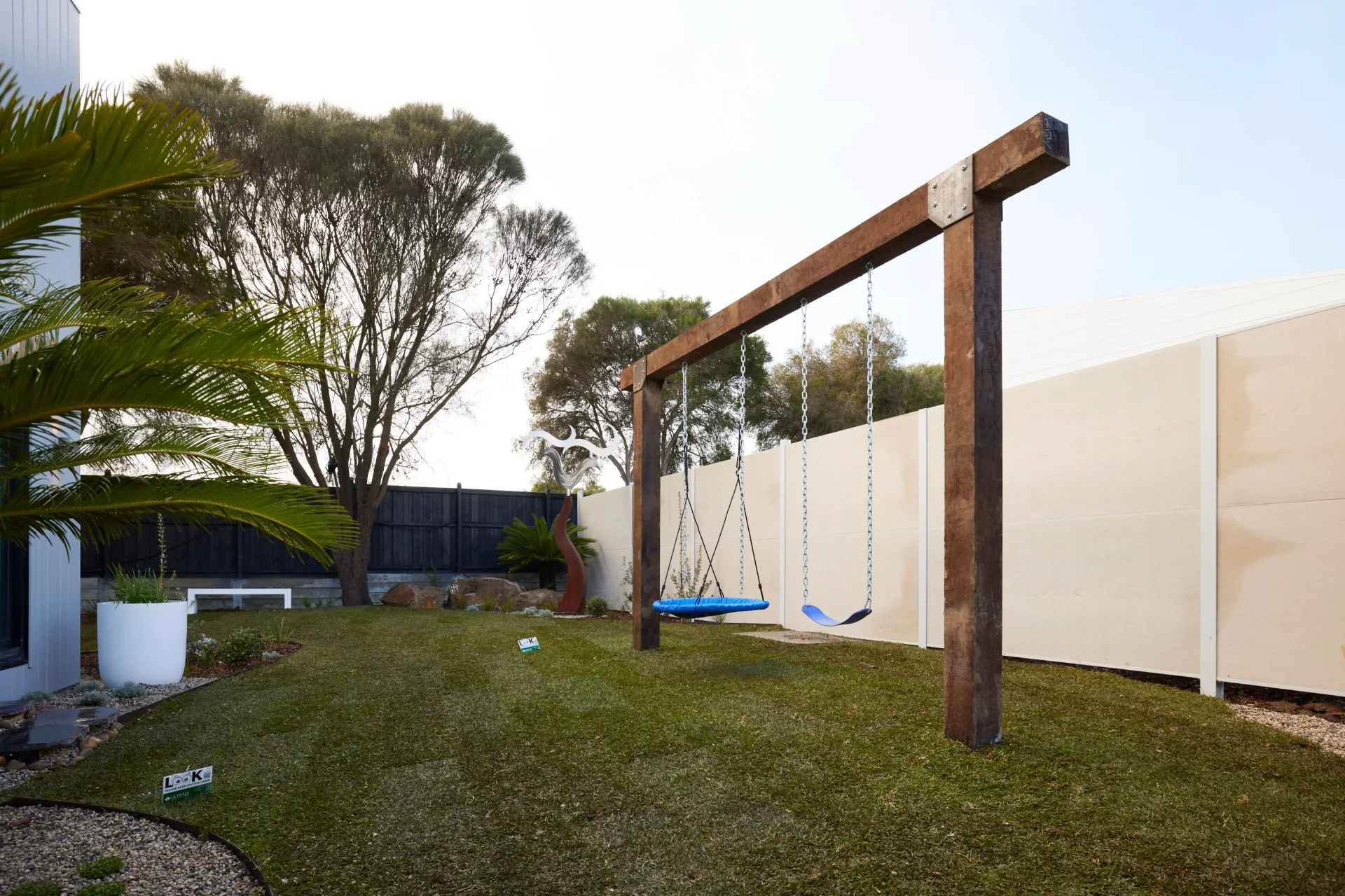 A heavy duty children's swing set made from recycled wood in Ricky and Haydn's backyard on The Block