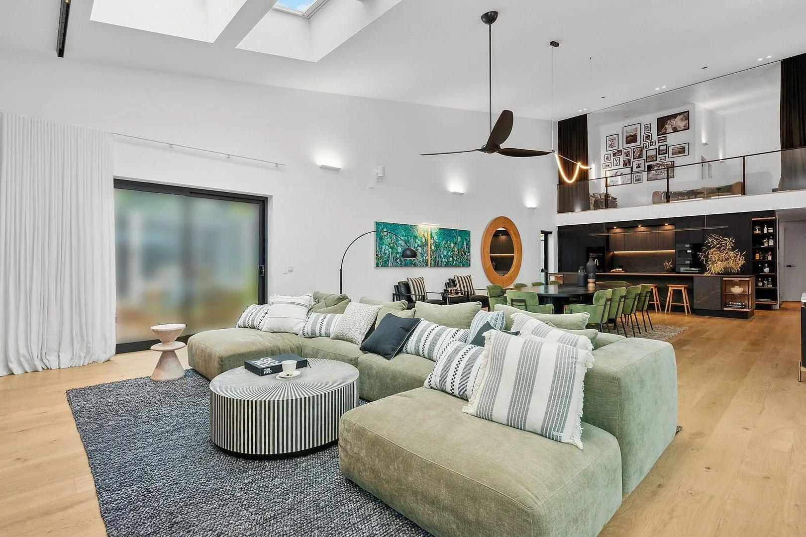 Kylie and Brad's green, black and white living, kitchen and dining on The Block