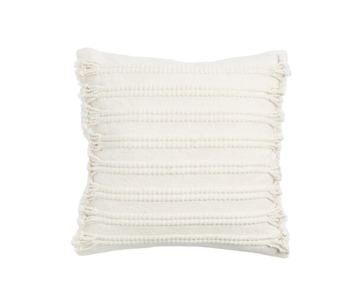 A white tasselled pillow