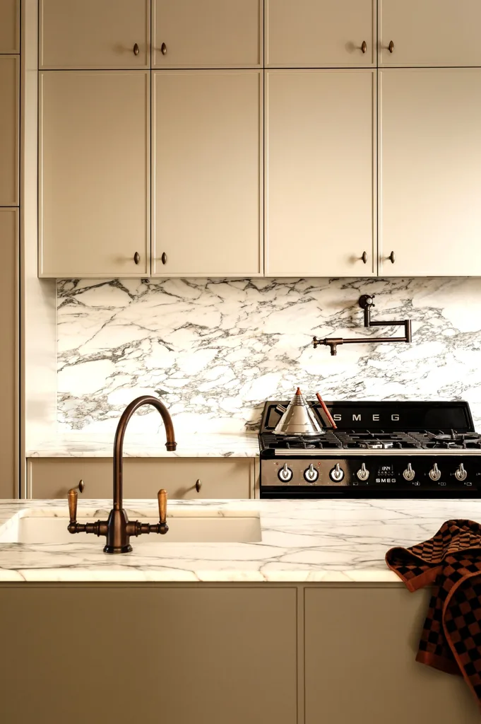A renovated terrace kitchen with a chrome kettle on the stove