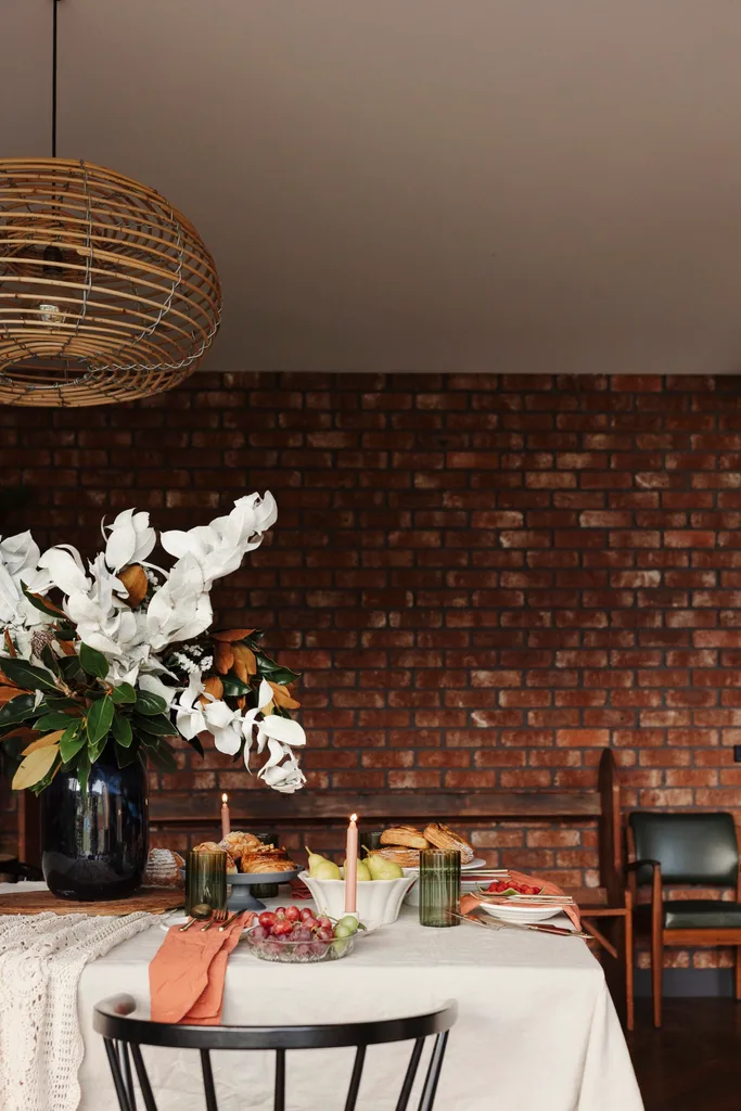 A dining area with exposed red brick walls