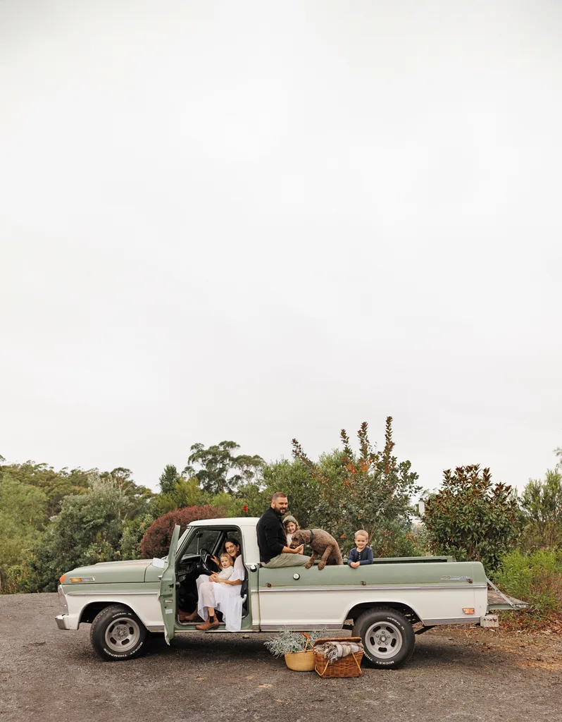 A family sat in an old green and beige ute