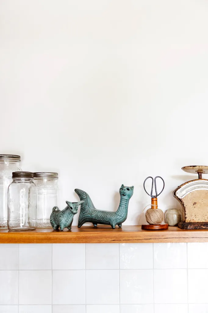 A close up of trinkets and mason jars on a shelf