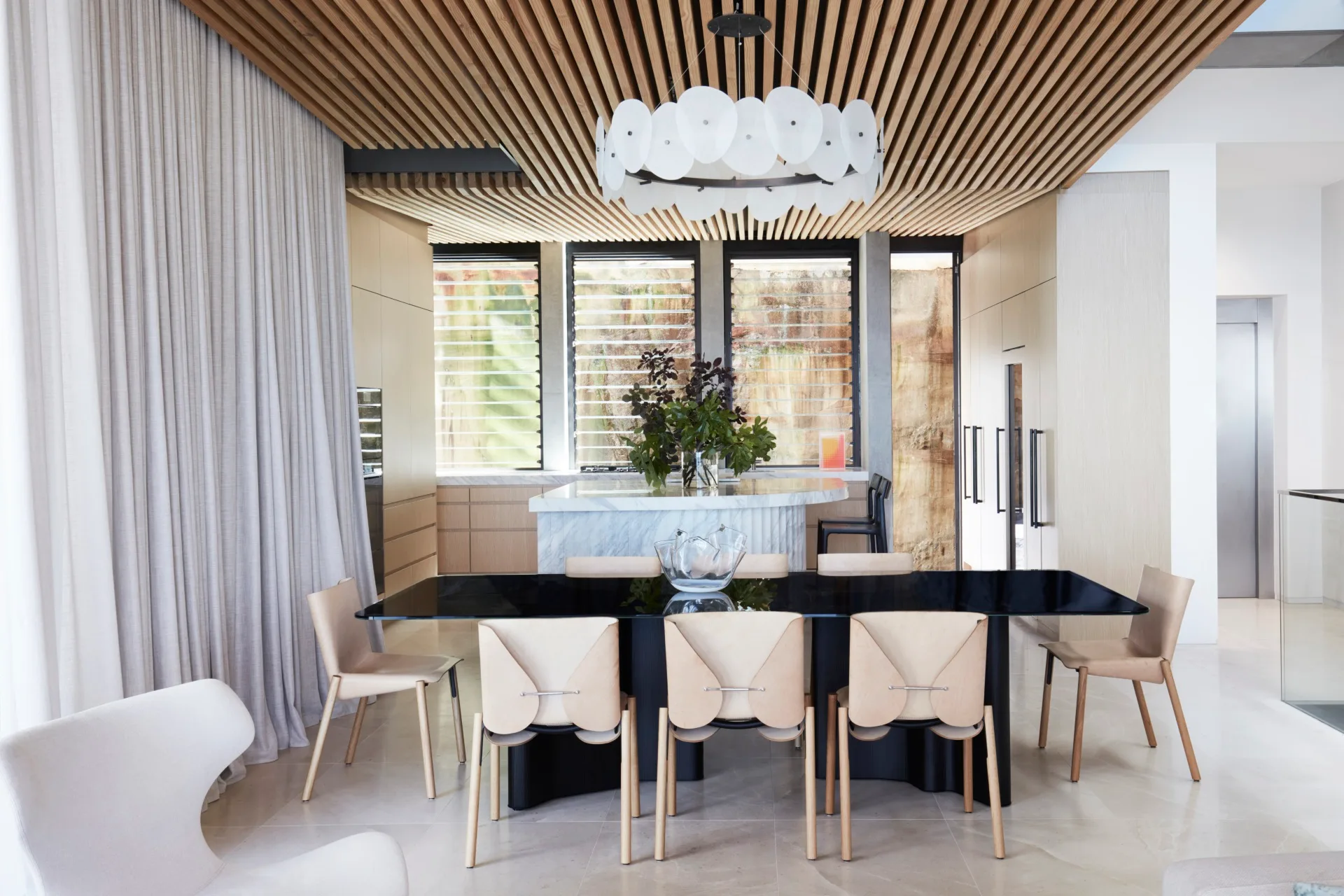A contemporary open-plan dining and kitchen in David Warner home