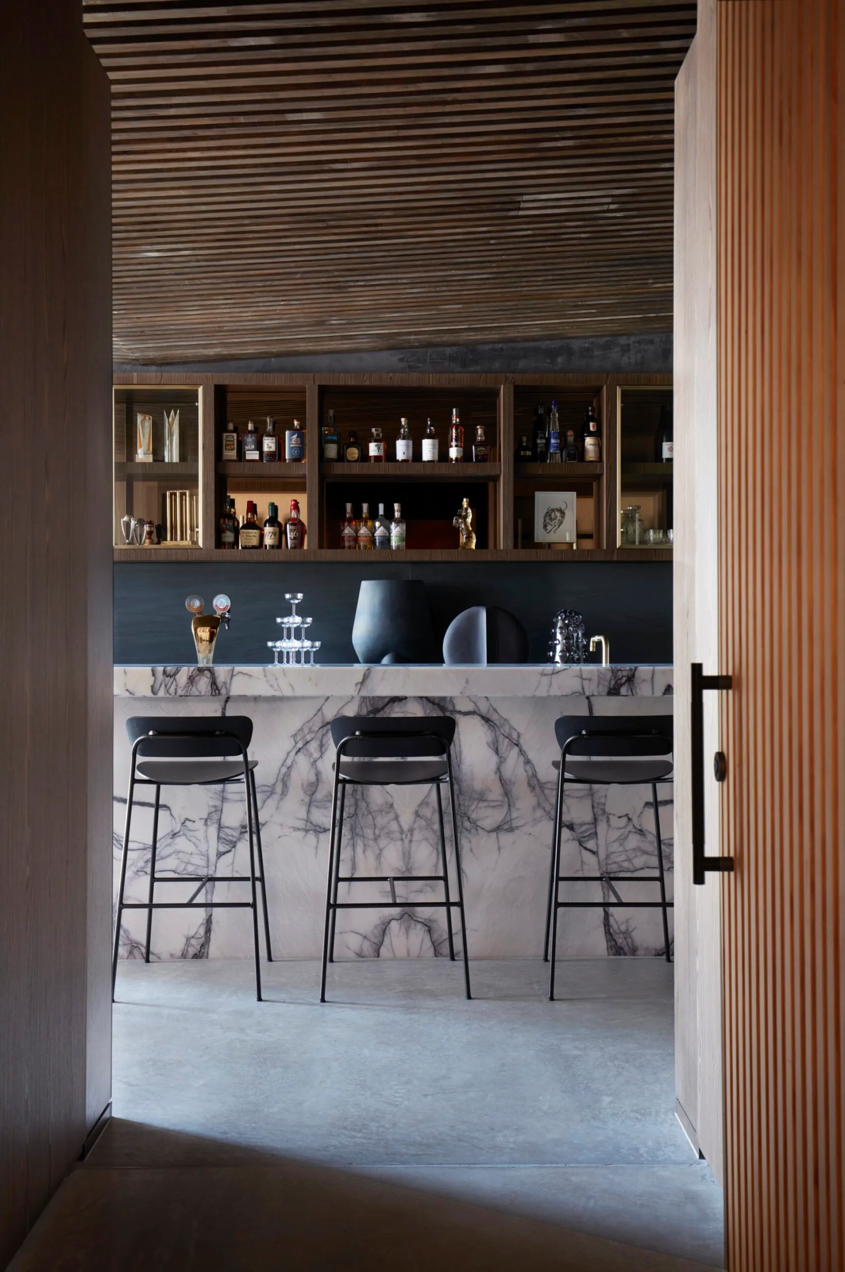 A sleek bar area with a marble island bench