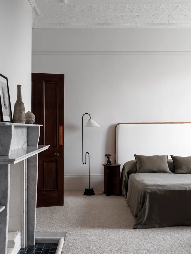 A white, black and grey bedroom with minimalist styling in a Southern NSW homestead