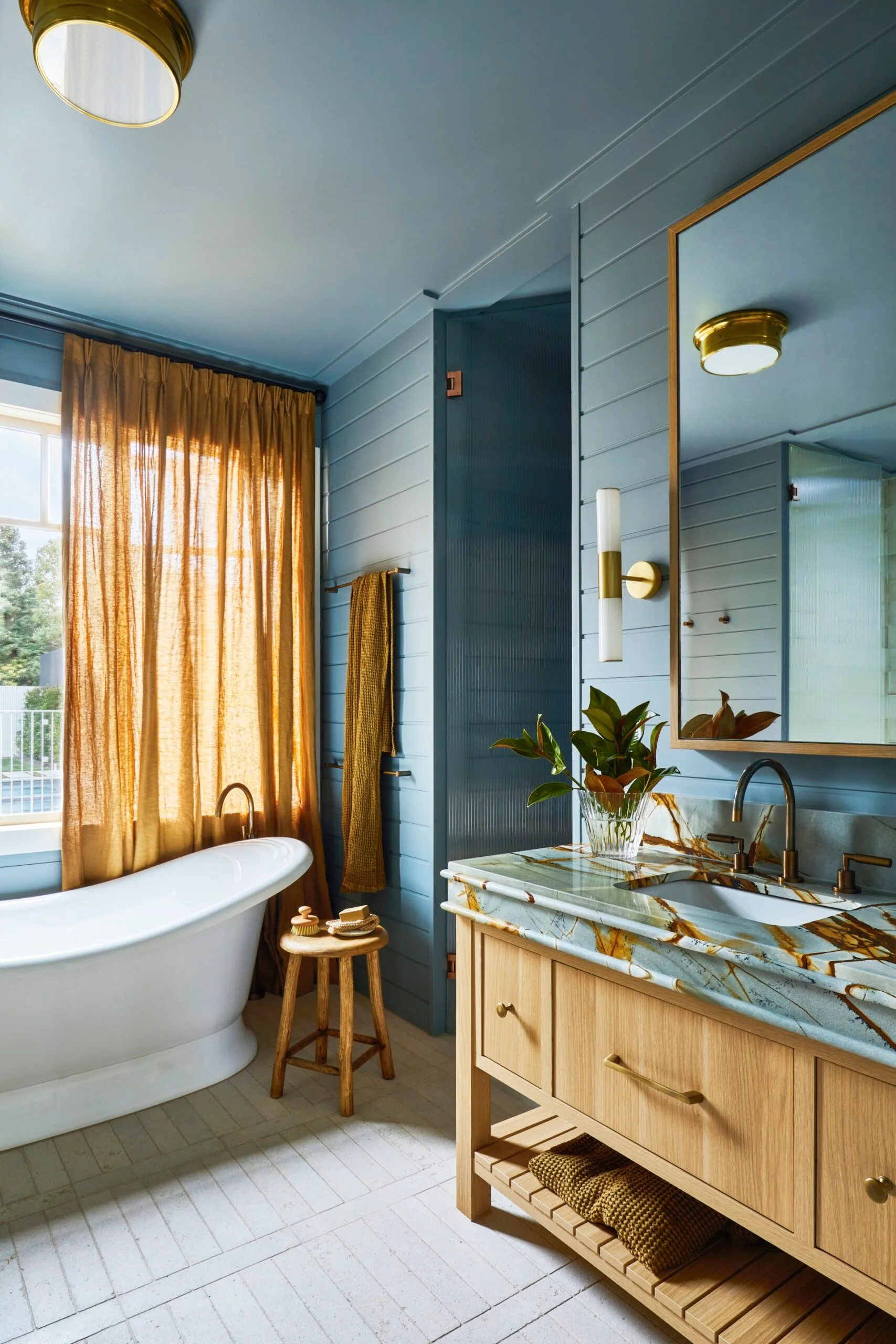 Contemporary blue bathroom with a freestanding tub and weatherboard walls