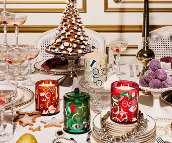 A table decorated with champagne, gingerbread and Glasshouse candles