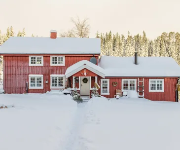 Red farmhouse in the snow