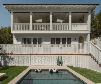 The back exterior of a Hamptons-style white double story house in Sydney