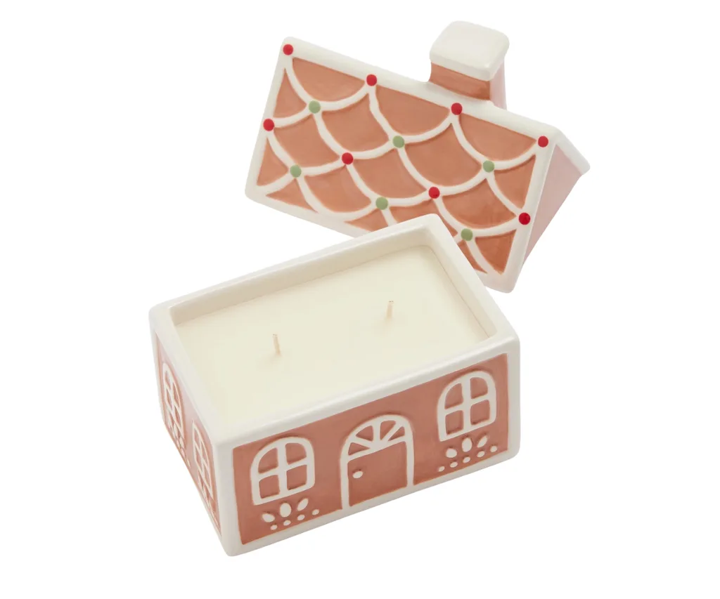 A gingerbread house-shaped candle