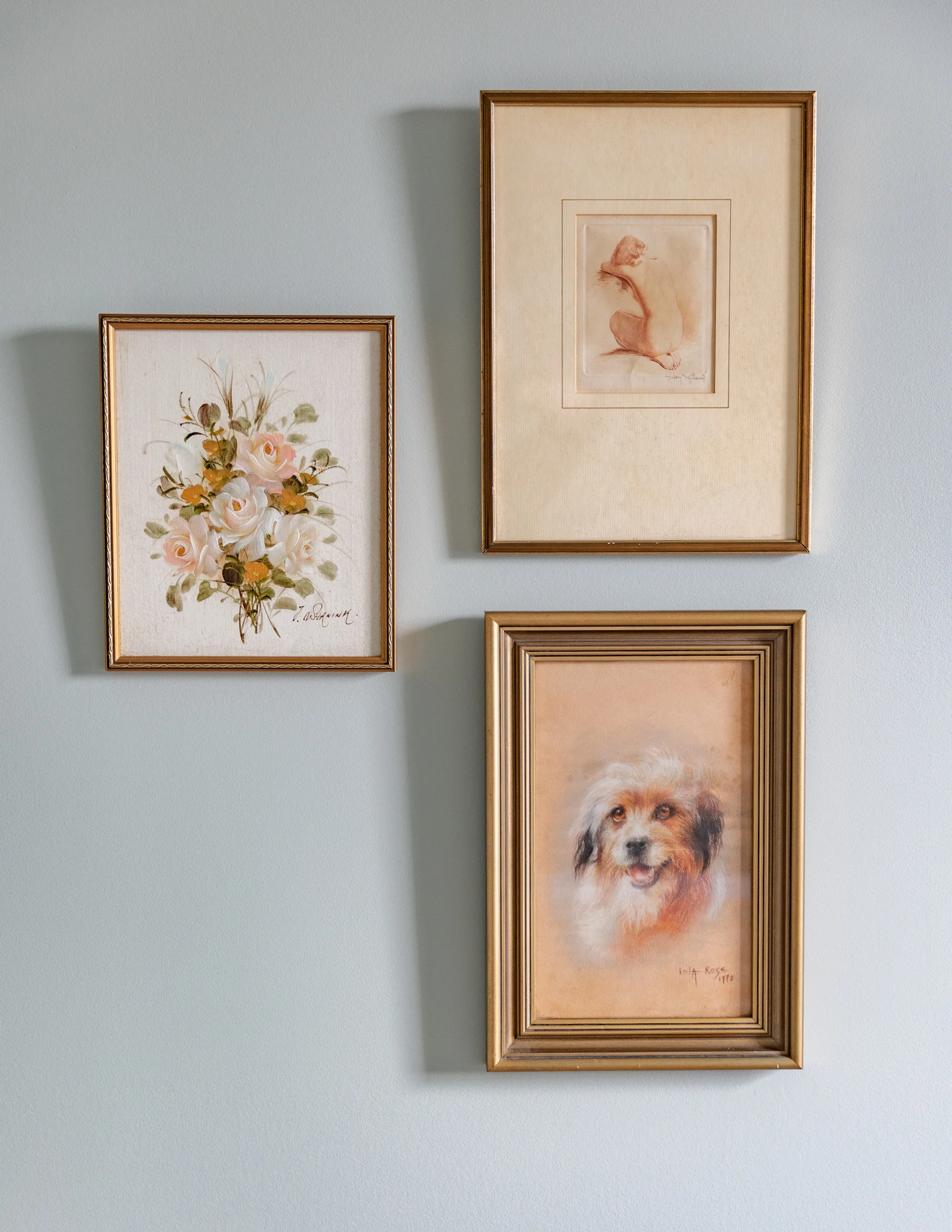 Three gold-framed mirrors on a powder blue wall