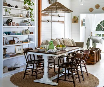 An eclectic coastal living room filled with antiques