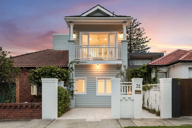 The facade of a compact, two-level weatherboard home