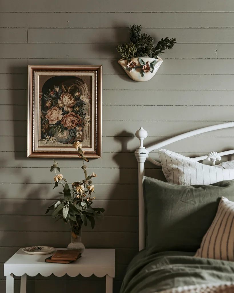 A bedroom with khaki coloured walls and floral decorative features