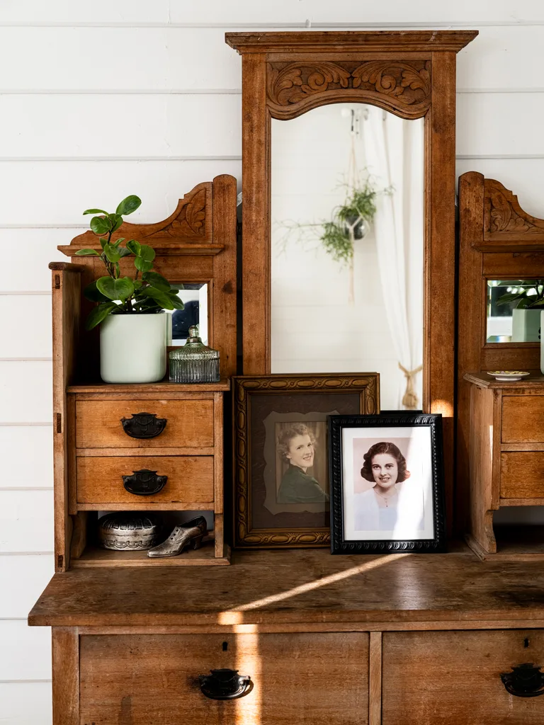 A vintage dressing table holds antiques and heirlooms.