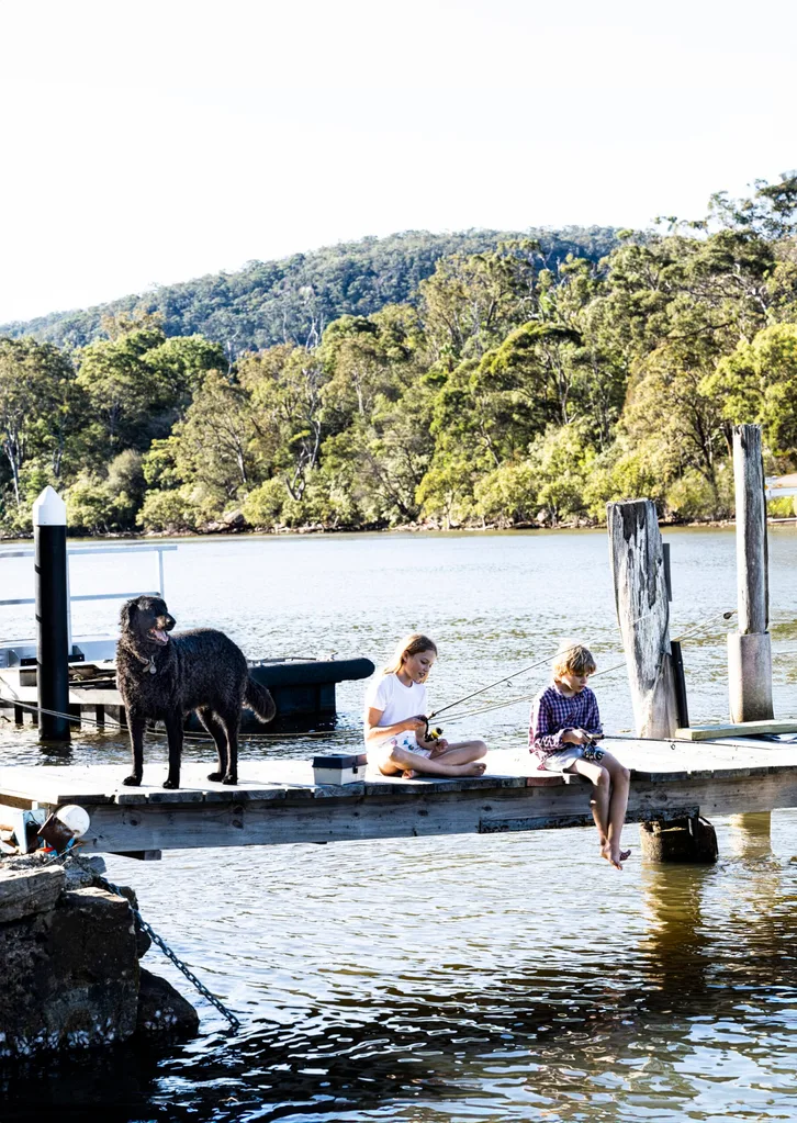 Children fish off a private jetty.