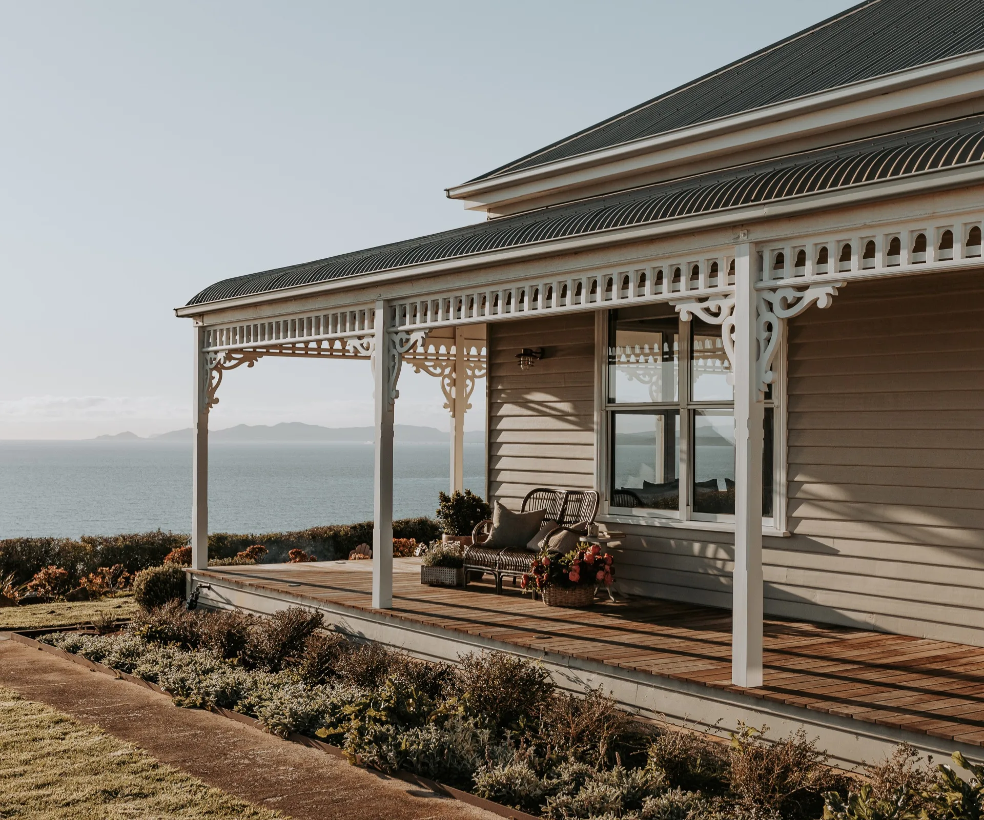 The exterior of a weatherboard house with a wraparound balcony