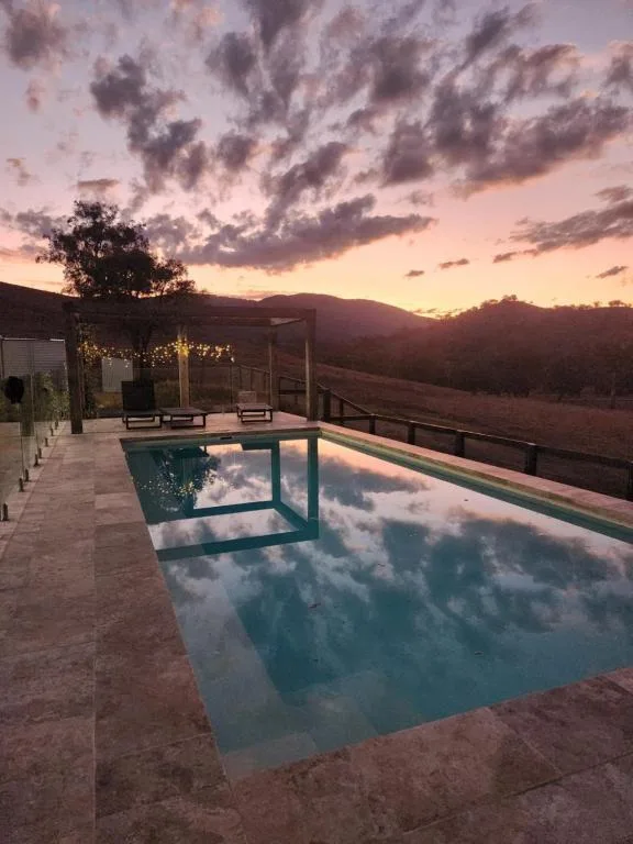 Outdoor pool at sunset with view over Upper Hunter Valley
