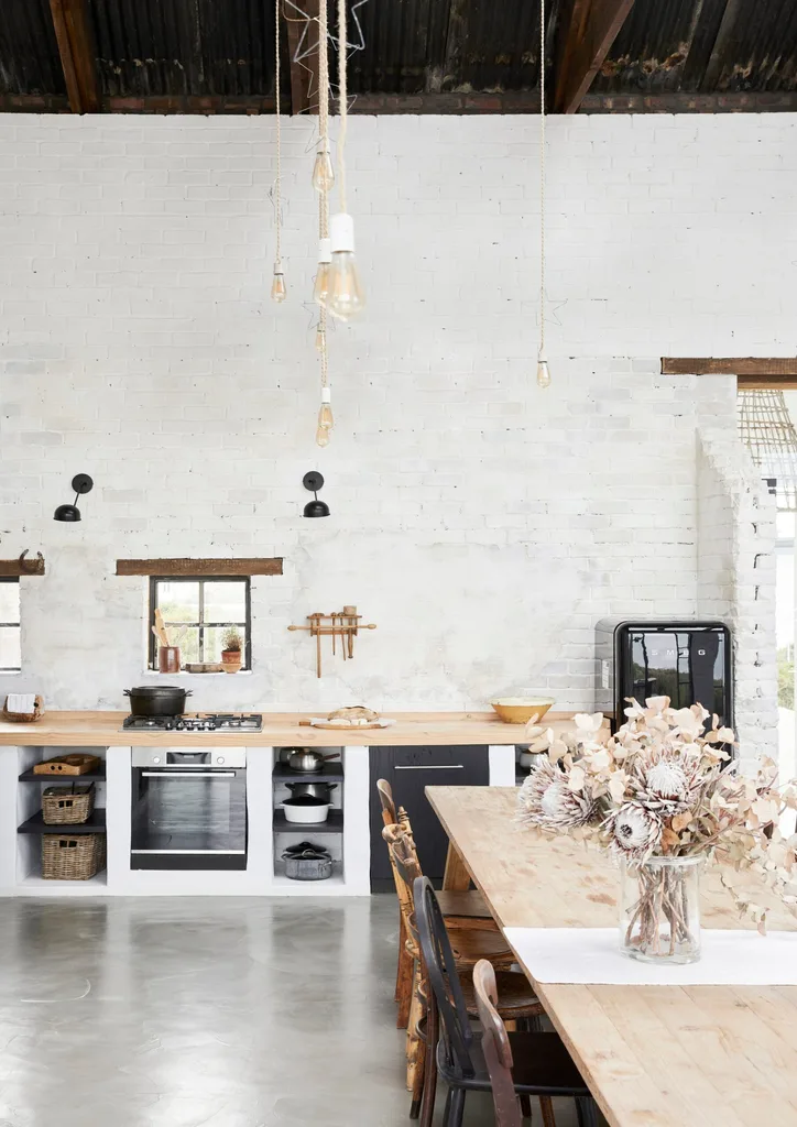 A rustic barn kitchen with white brick walls and wooden accents