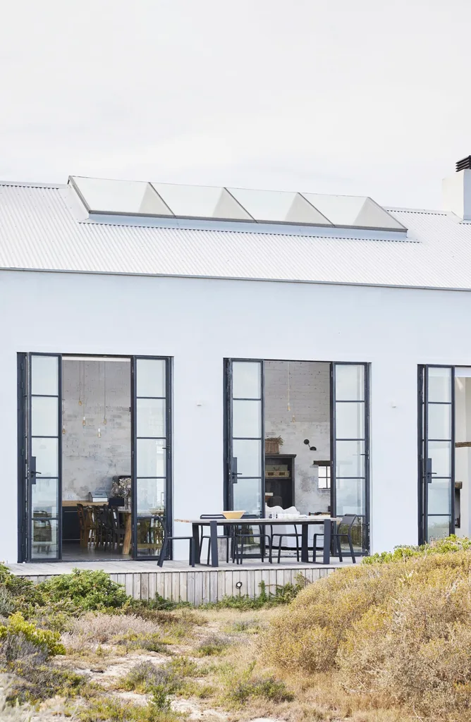 The exterior of a contemporary barn-style home with double-height doors