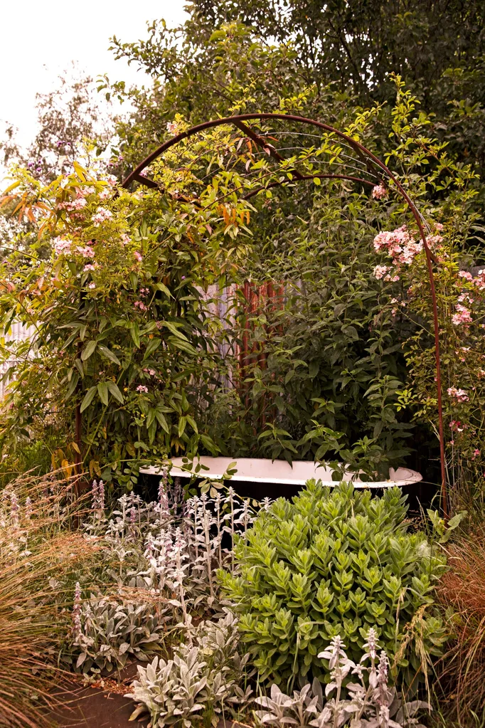 An old bathtub sits in a quiet corner of a garden designed by Tim Pilgrim