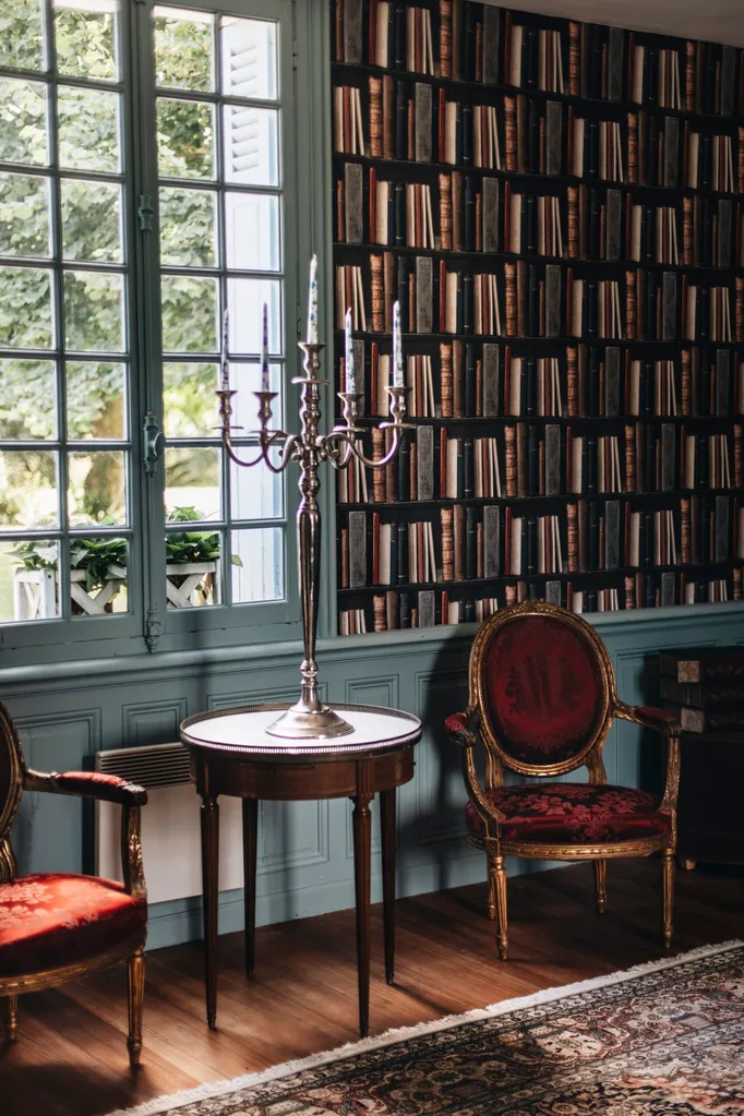 A beautiful library interior with gilt chairs.