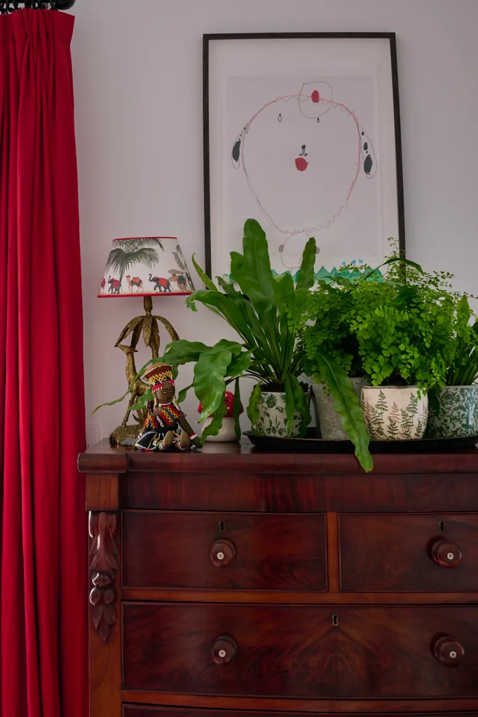 A timber dresser topped with plants