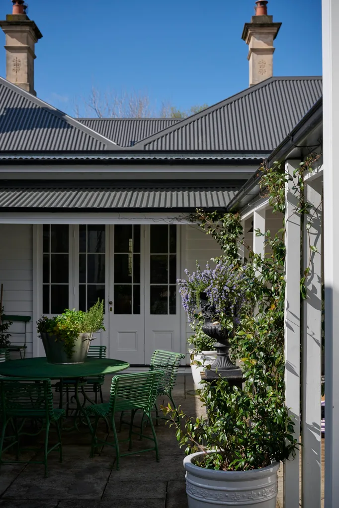 Collette Dinnigan placed a green outdoor setting beside her heritage home in Bowral