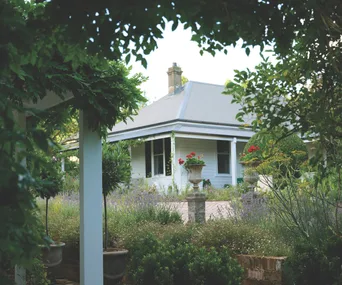 A view of Collette Dinnigan's Southern Highlands retreat from a leafy garden