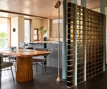 A contemporary kitchen featuring a glass block divider