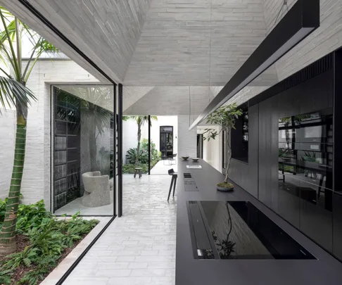 The modern monochrome extension of this terrace home evokes a monastic sanctuary