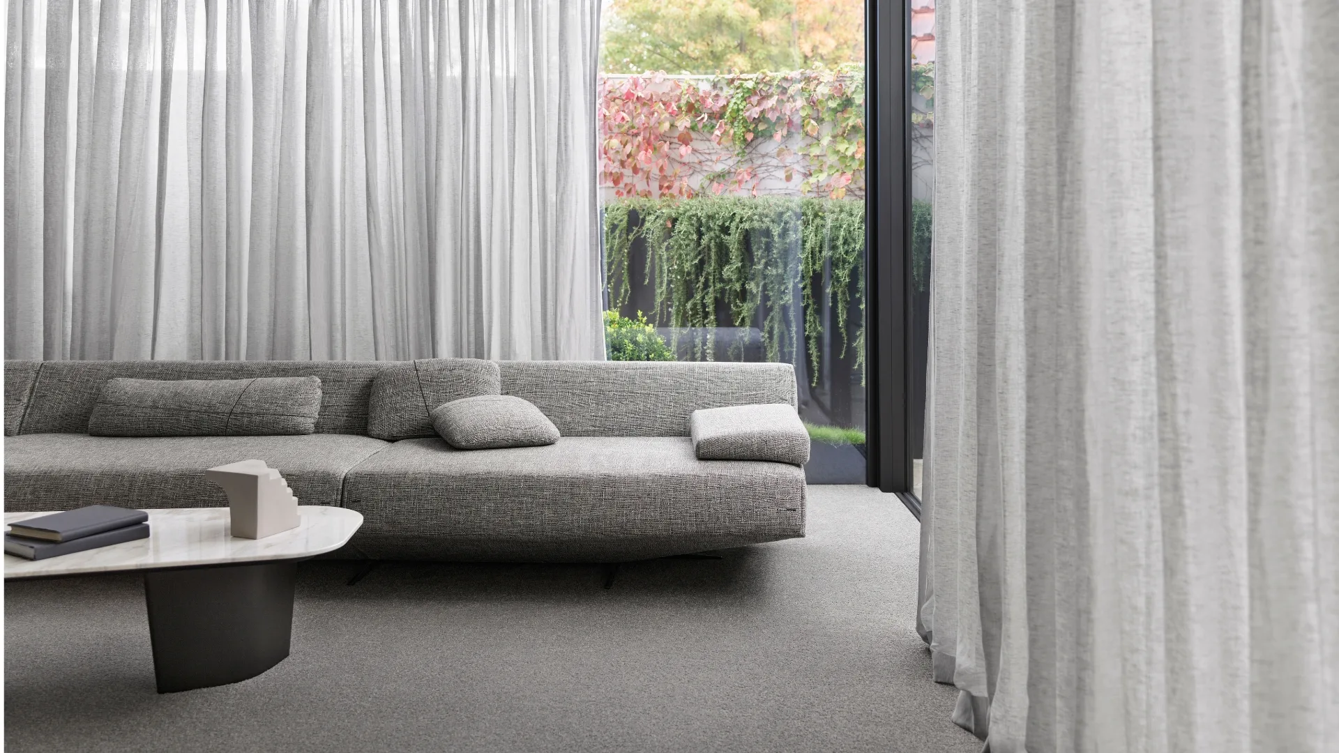 In this Australian home, &lsquo;Bali&rsquo; sheer curtains in 'Ash&rsquo; by Carpet Court filter natural light to create a calm haven. Image: Supplied