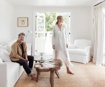 Tim Ross and Michelle Glew-Ross in their white living room in the Northern Rivers