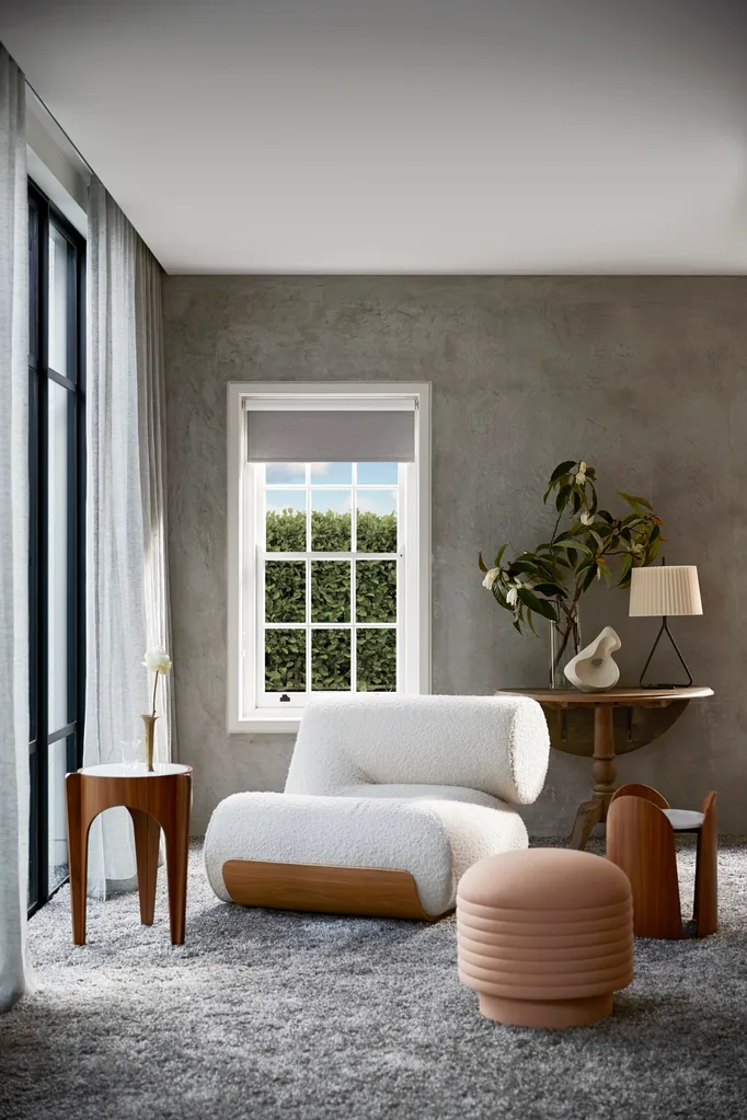 A sitting area with a boucle armchair in a grey room