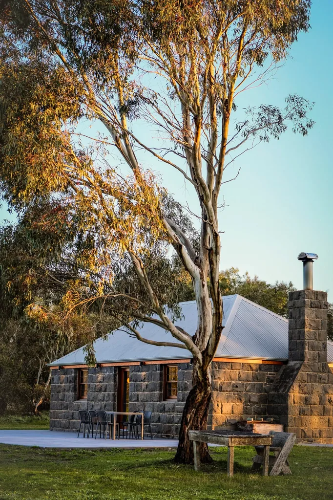 Stone cottage under a tree in a travel story about a Grampians hotel