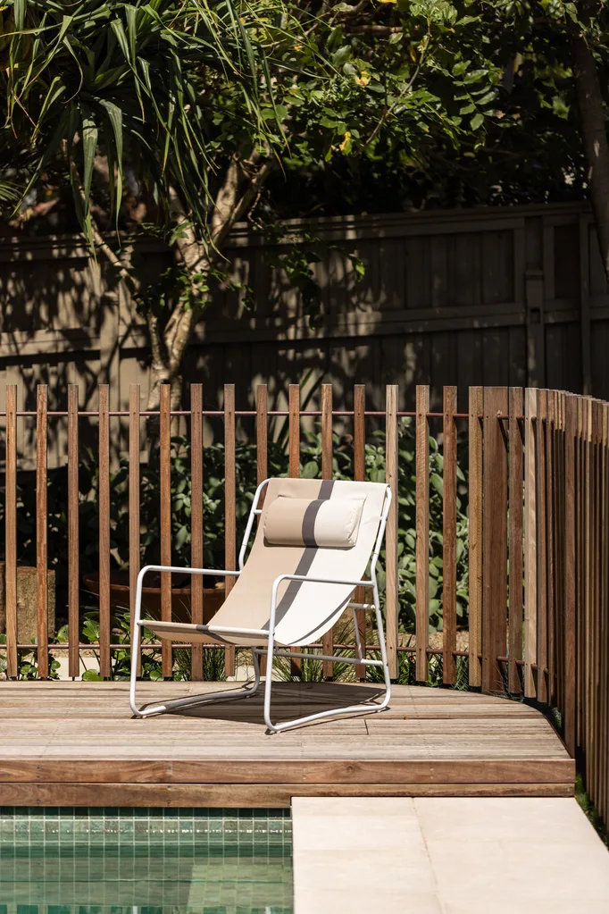 A lounge chair on a poolside sundeck