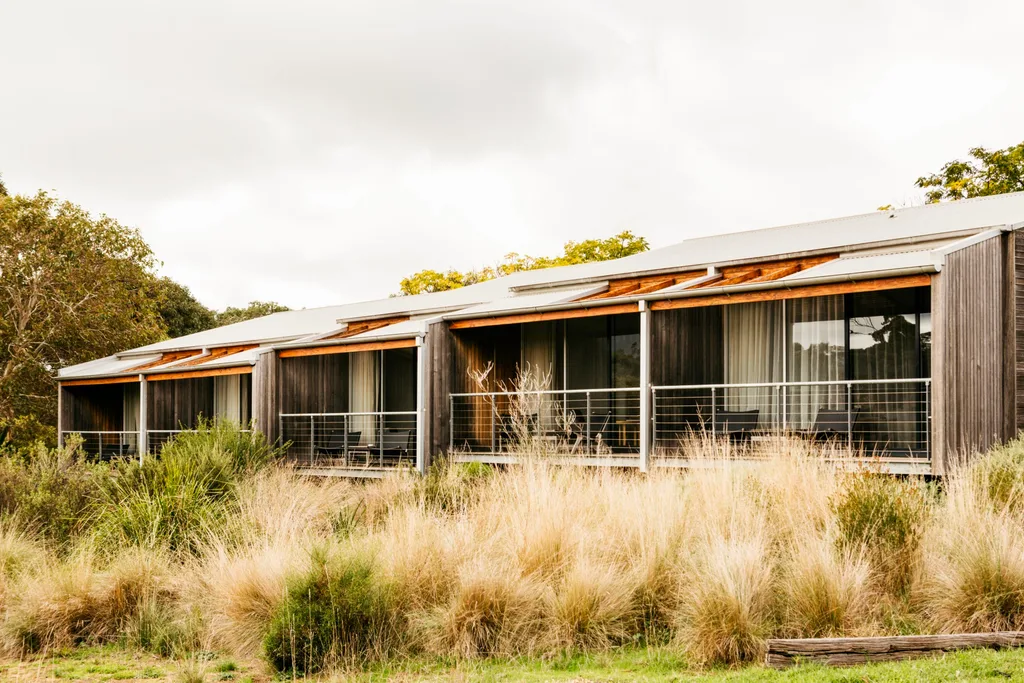 Long timber building with verandahs for each room, with grasses in front in a travel story about a Grampians hotel