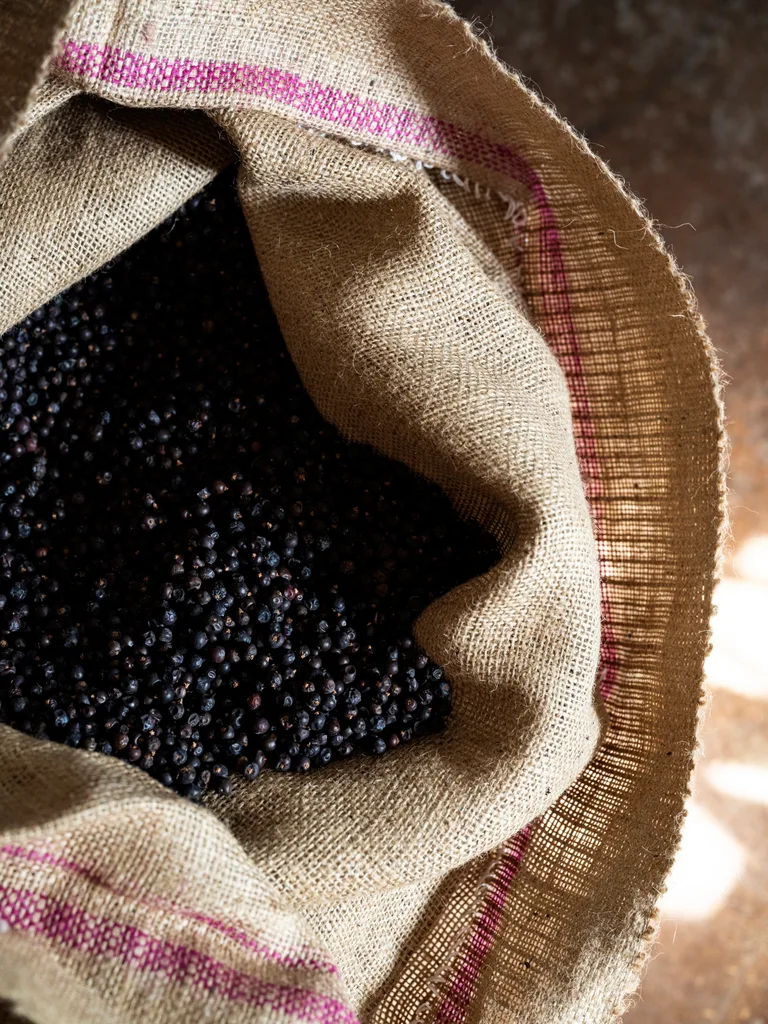Hessian bag full of small dried dark red berries