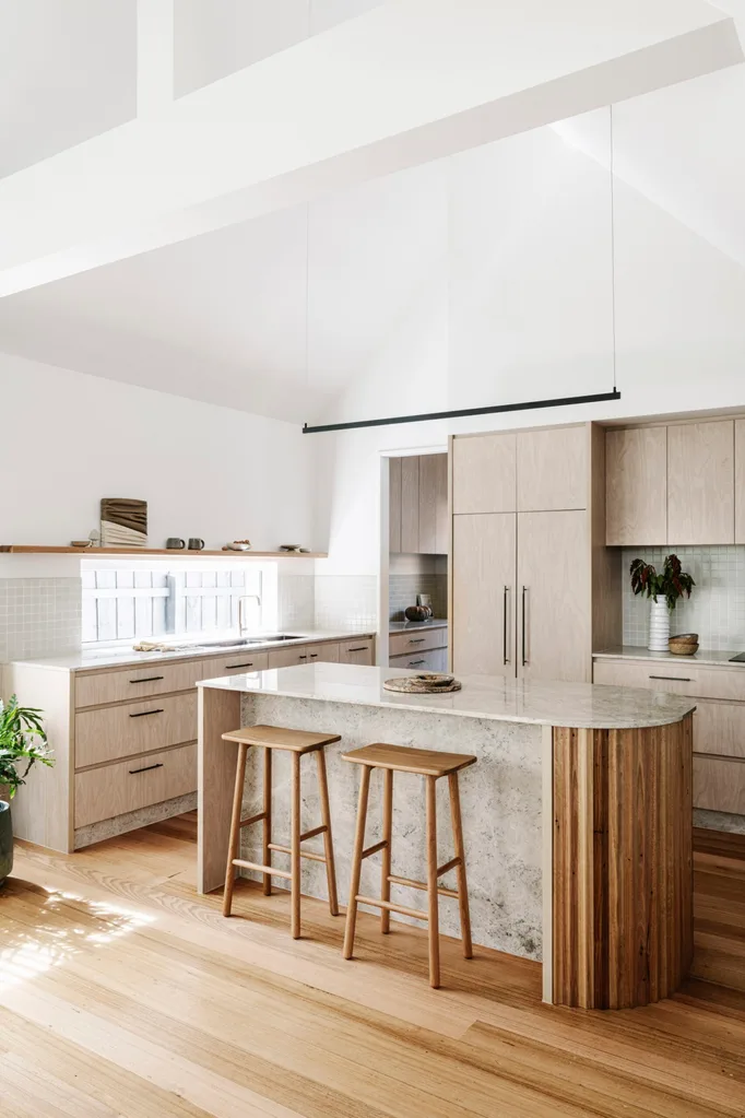 A kitchen with stone and timber finishes