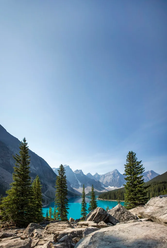 Bright blue lake surrounded by fir trees and steep mountains