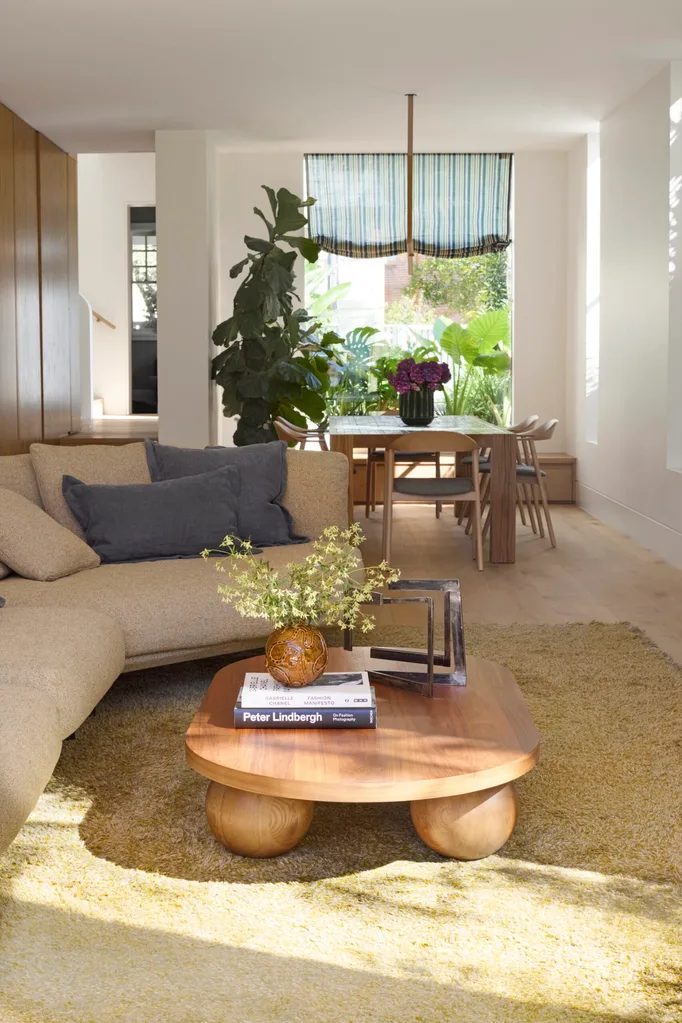 a lounge and dining space with timber furnishings