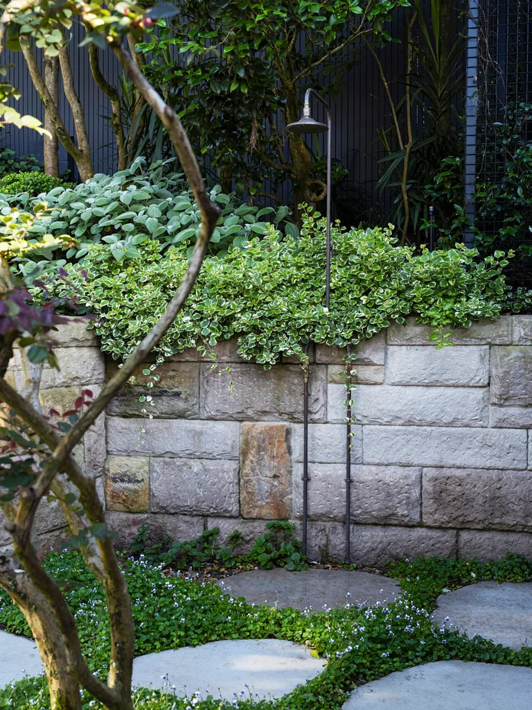 A small outdoor shower in a lush garden