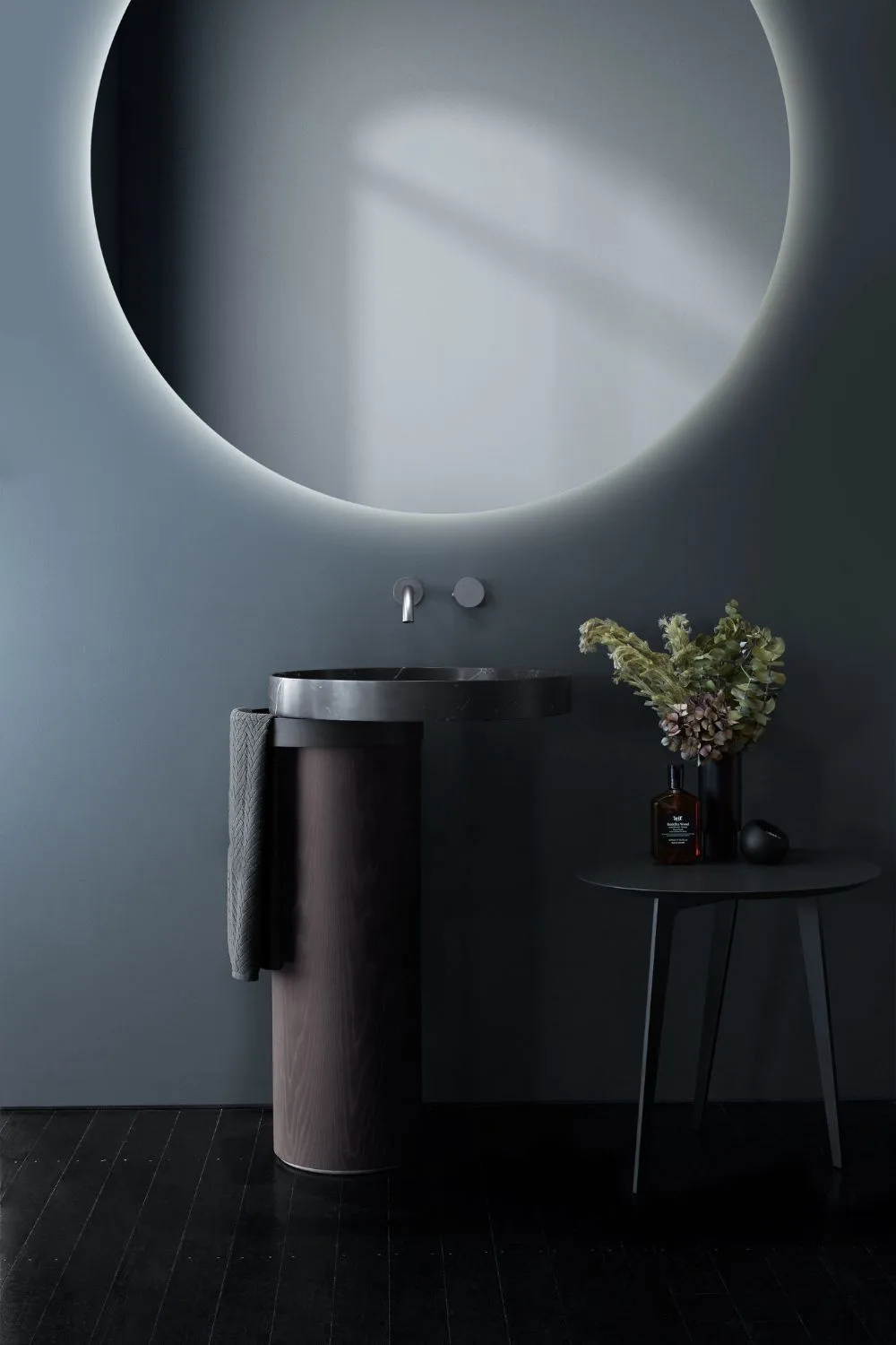 Rogersellers eccentric range in moody bathroom with round mirror and basin