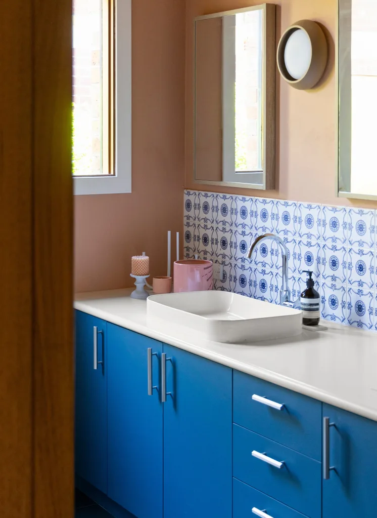 A blue and pink bathroom with bold tiling
