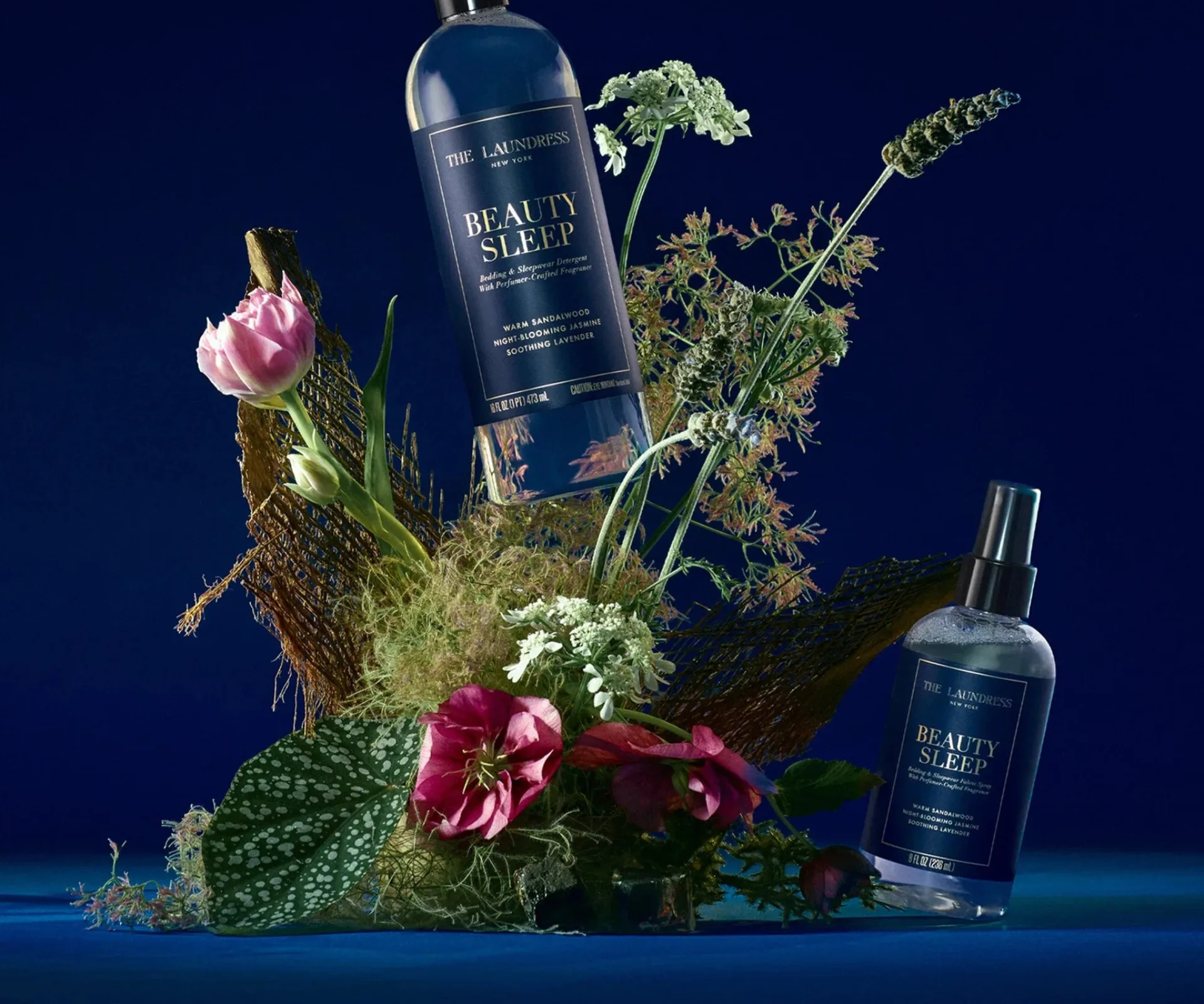 A blue background, flower arrangement and blue laundry products