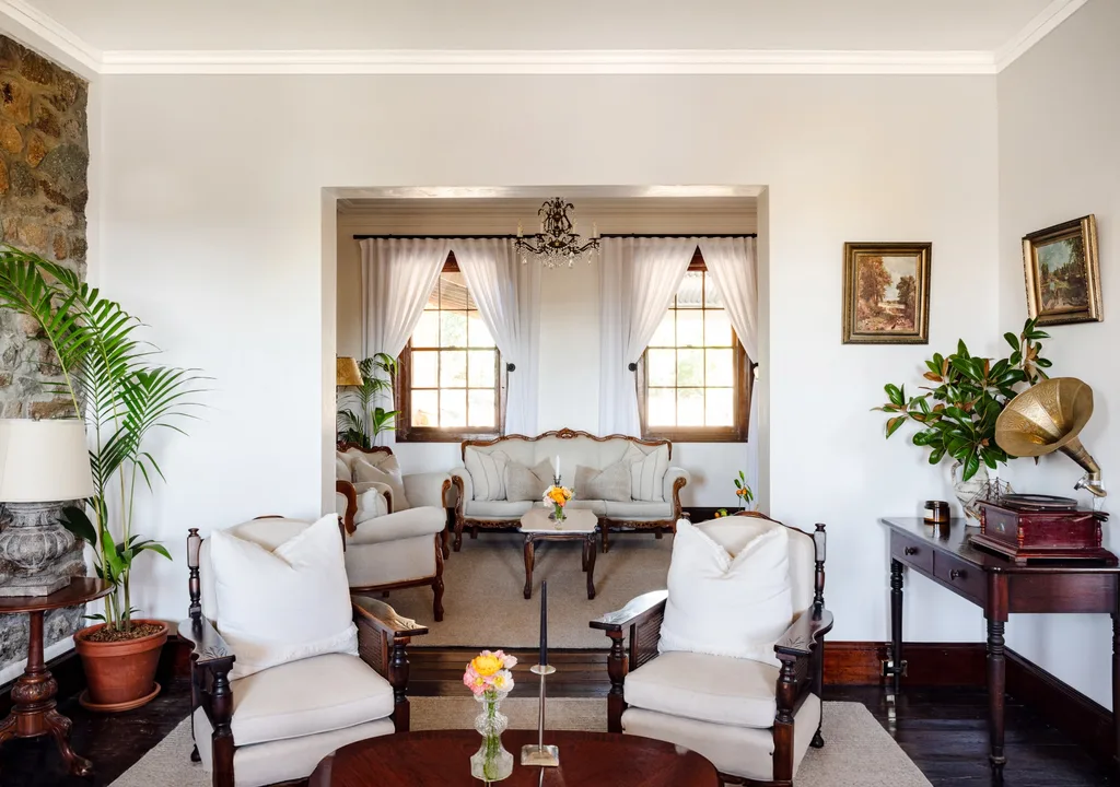 A cosy living room filled with antique furniture.