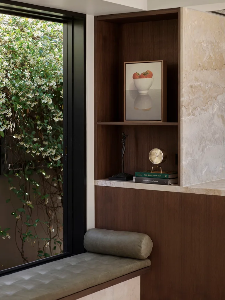 A built-in window seat sits next to custom joinery