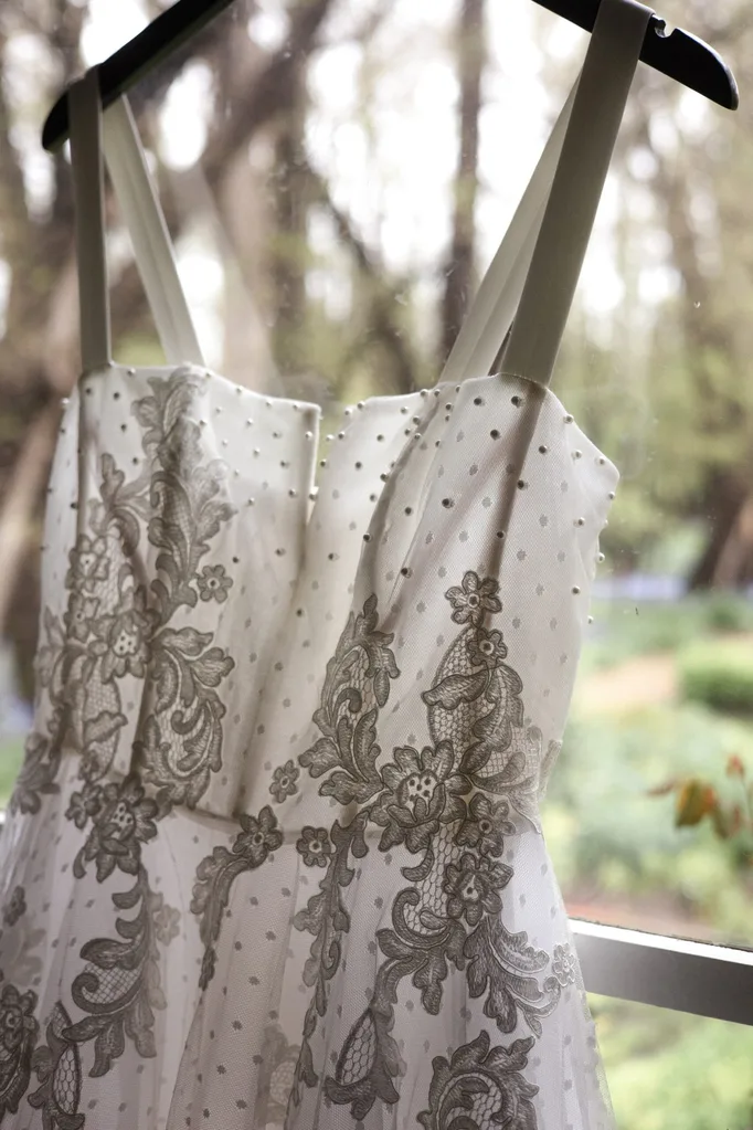 Sally's wedding dress hanging by the window